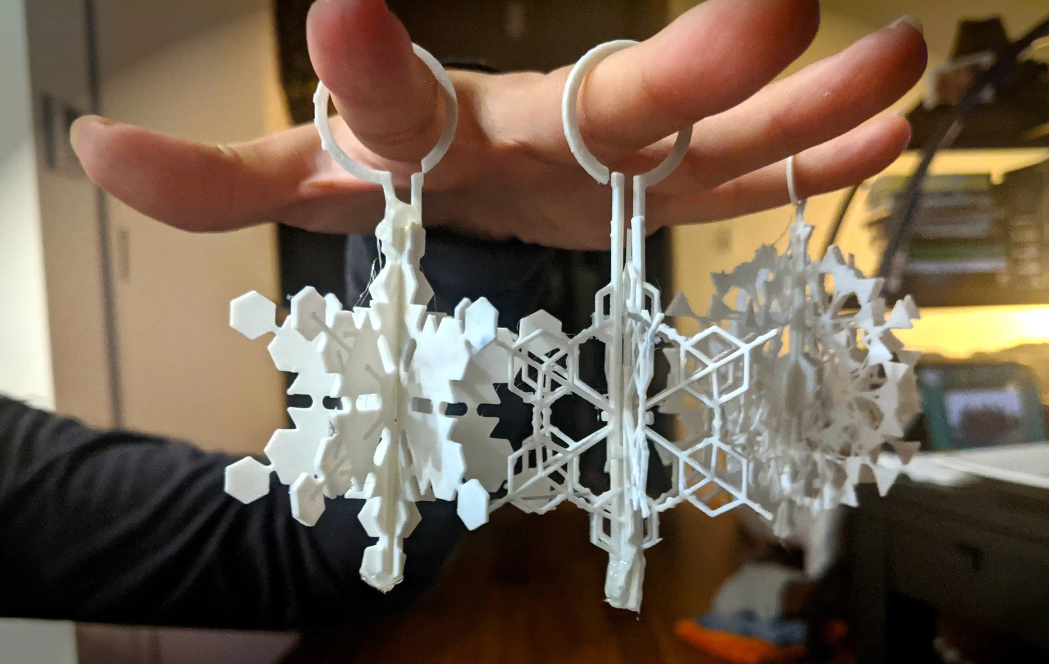 Holding 3D printed snowflake ornaments